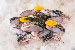 Pacific West Barramundi Fillets Portions On Ice Skin On